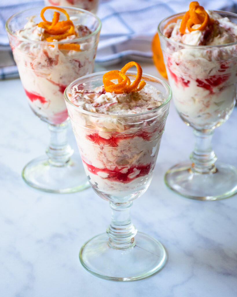 Three parfait glasses with rhubarb fool in them.