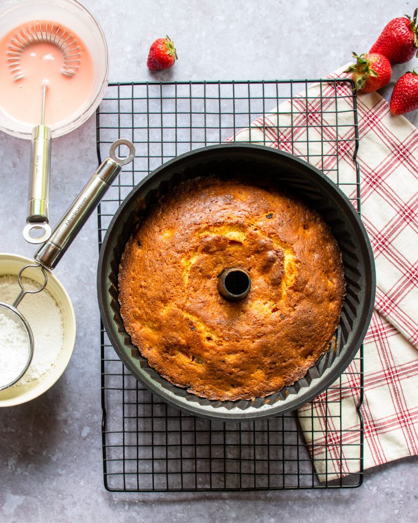 A bundt cake cooling on a cooling rack.