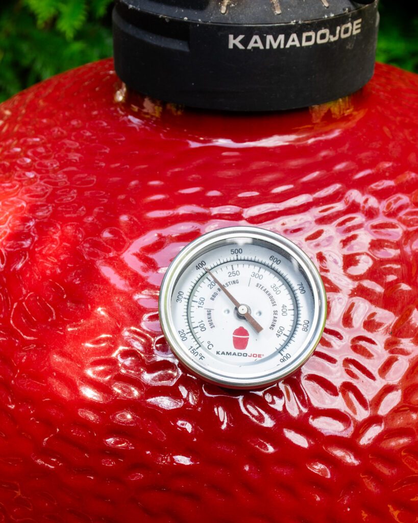 A temperature gauge on a red Kamado Joe BBQ, showing 400˚F.