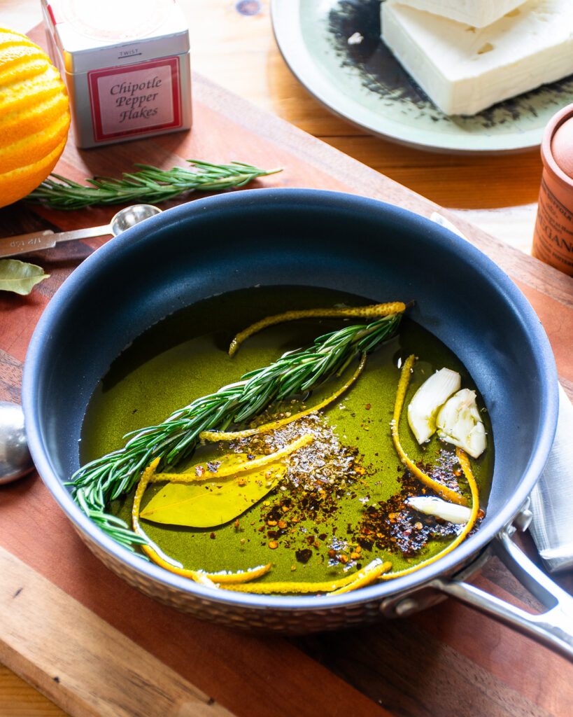 Oil, rosemary, bay leaf, dried spices and garlic in a small skillet.